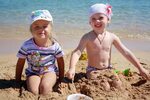 Little girls in the sand near the water on a sunny day free 